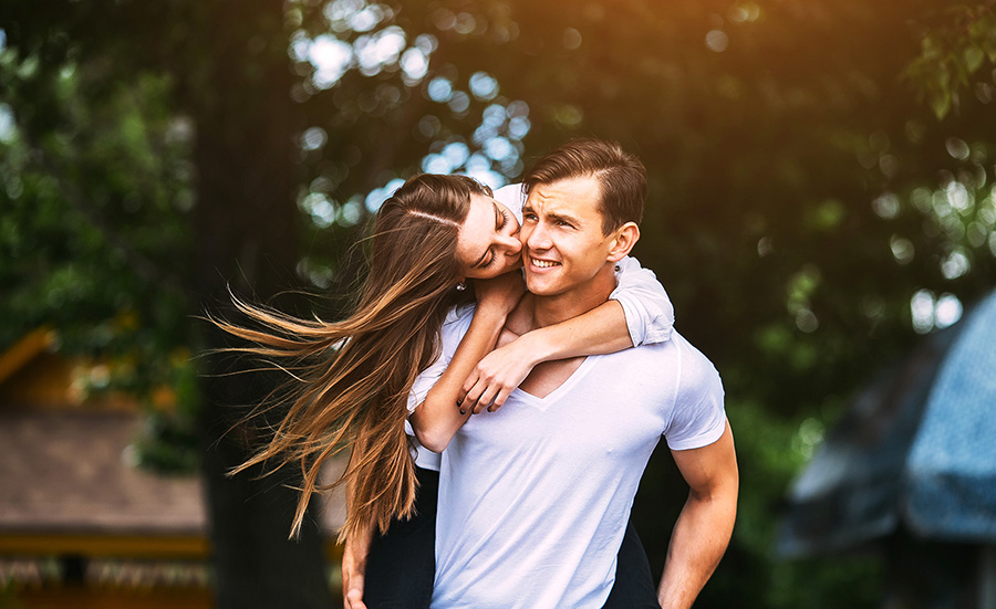 Young adult brunette man and woman in the park