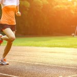 Athletic woman running on track